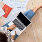 top-view-professional-young-businesswoman-working-home_273609-20483